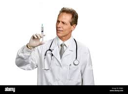Physician reviewing a syringe against a white background